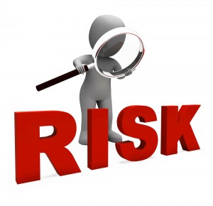 Risk word inspected by cartoon man with magnifying glass